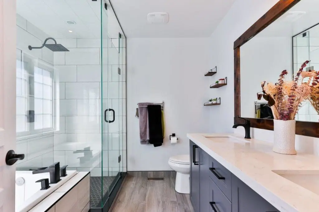 A pristine bathroom with a transparent shower enclosure.