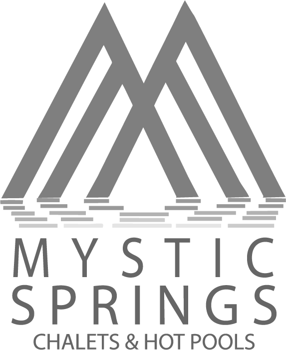 Mystic Springs Chalets and Hot Pools logo with overlapping mountain lines forming an M above stylized water waves