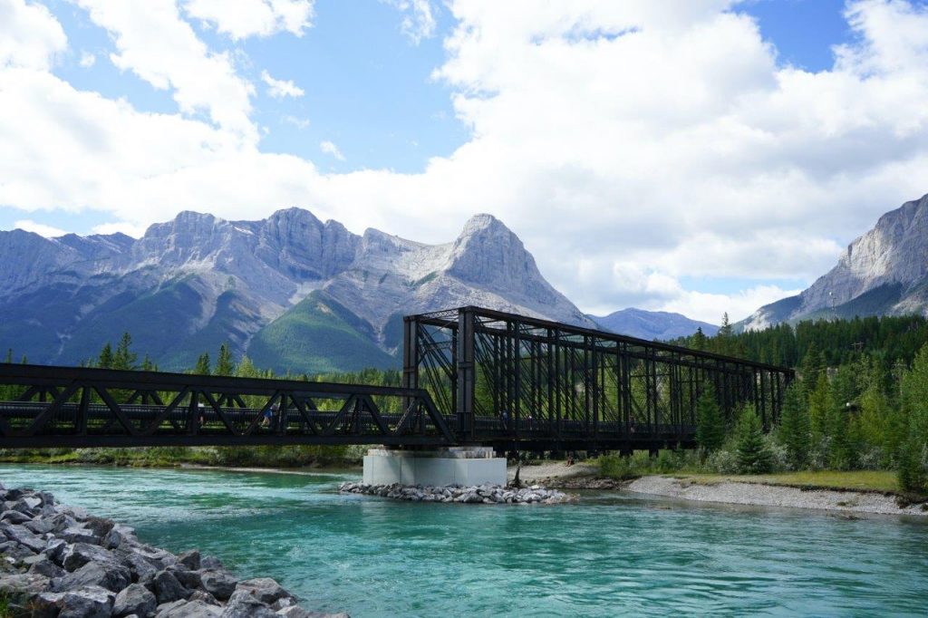 Scenic train bridge over river in the mountains.