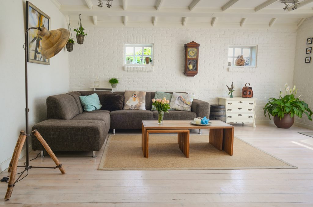 A cozy living room with a comfortable couch, a stylish coffee table, and a modern lamp.