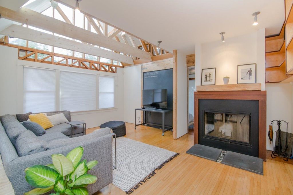 A cozy living room with a fireplace and a comfortable couch.